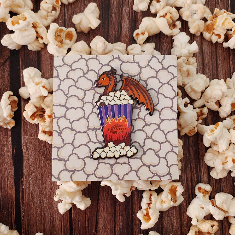 Dragon Roasted Popcorn Pin laying amongst popcorn