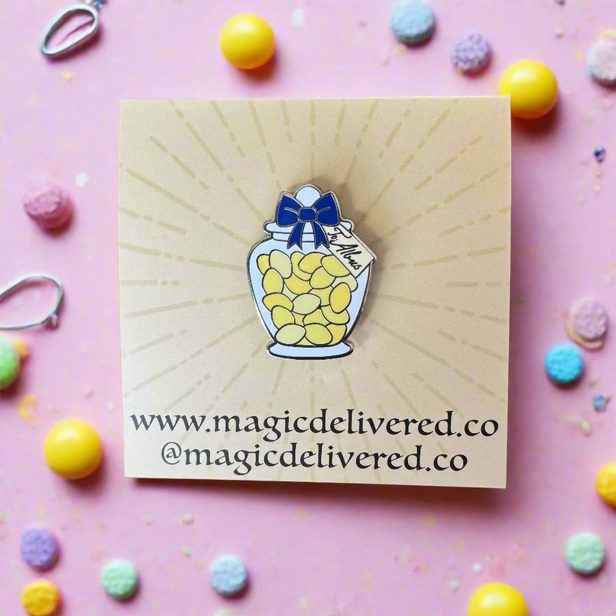 Lemon Sherbet enamel pin shaped like a ribbon‑tied candy jar filled with bright yellow sweets on backing card.